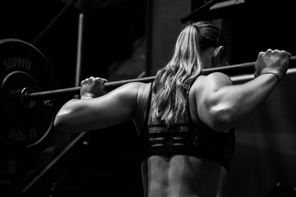 Woman performing squat during training session